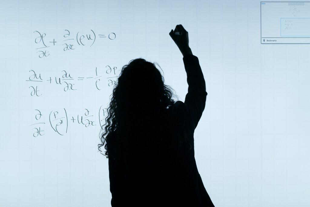 Expert online GCSE Maths tutor explaining complex equations on a whiteboard