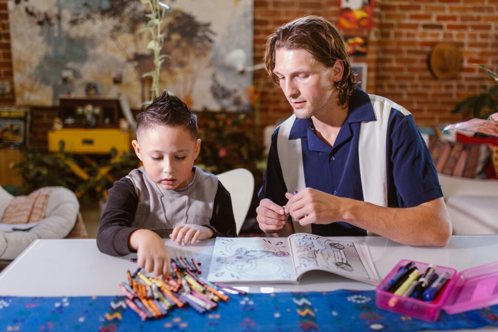 utor assisting a young student with a coloring book, highlighting personalised learning through online tutoring for GCSE success.